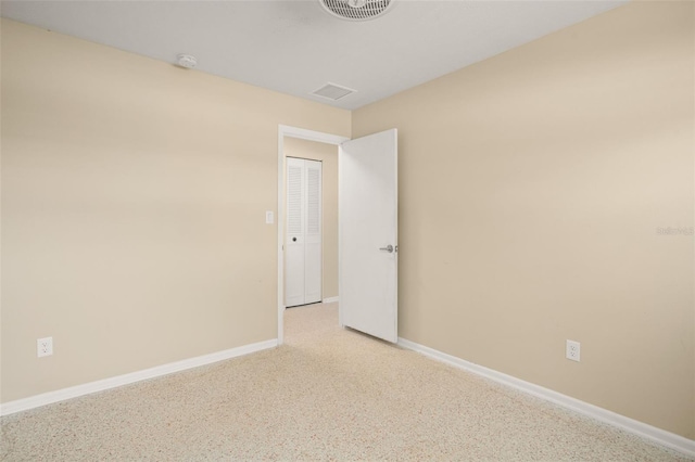 unfurnished room featuring visible vents and baseboards