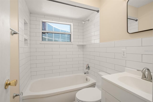 full bath featuring toilet, vanity, tile walls, and shower / bathing tub combination