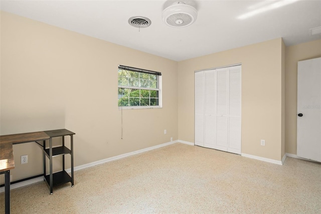 bedroom with a closet, visible vents, and baseboards