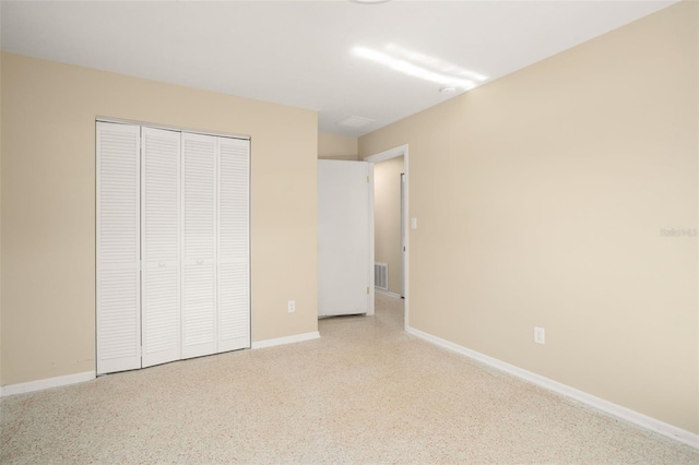 unfurnished bedroom featuring a closet, visible vents, and baseboards