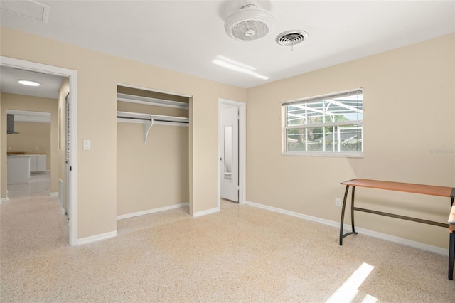 unfurnished bedroom featuring a closet, visible vents, and baseboards