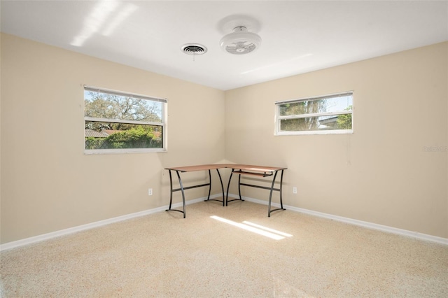 office area with a healthy amount of sunlight, baseboards, and visible vents