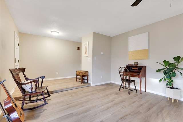 living area with ceiling fan, wood finished floors, and baseboards