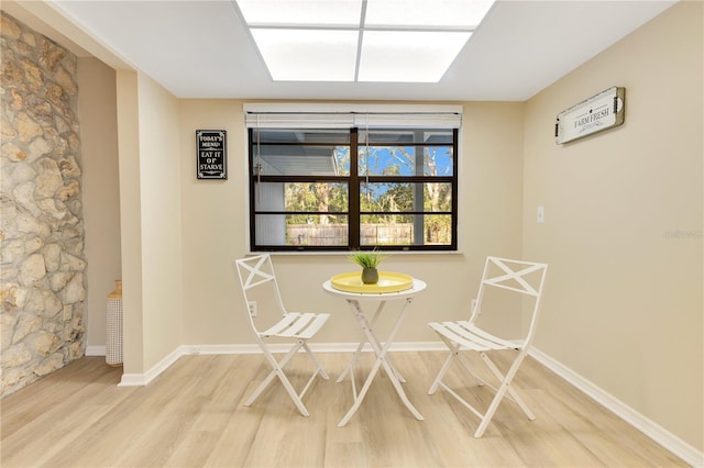 unfurnished dining area featuring wood finished floors and baseboards