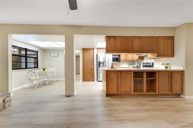 kitchen featuring brown cabinets, light wood-style flooring, stainless steel refrigerator with ice dispenser, and light countertops