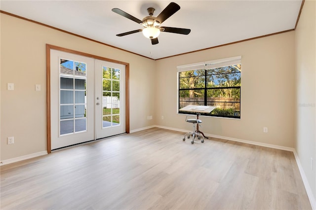 empty room featuring a wealth of natural light, french doors, and light wood finished floors