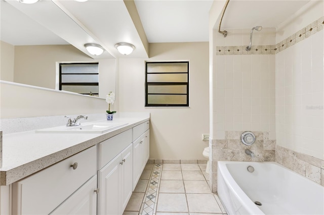 full bathroom featuring toilet, vanity, baseboards,  shower combination, and tile patterned floors