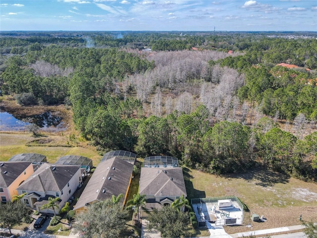 drone / aerial view featuring a wooded view