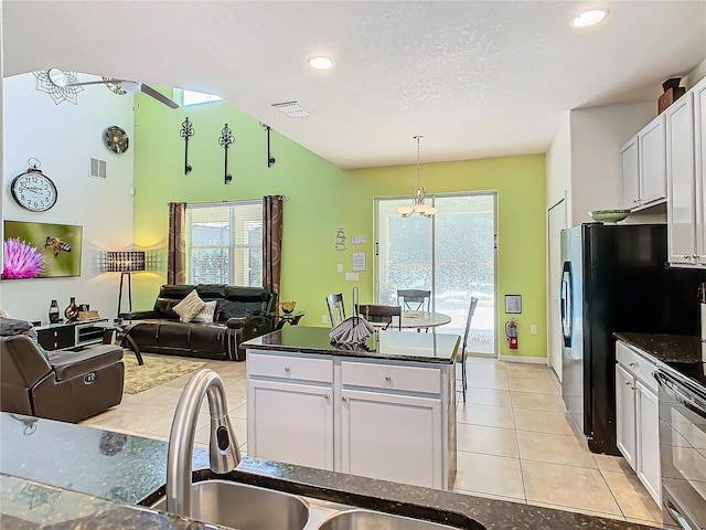 kitchen featuring white cabinetry, open floor plan, visible vents, and light tile patterned floors