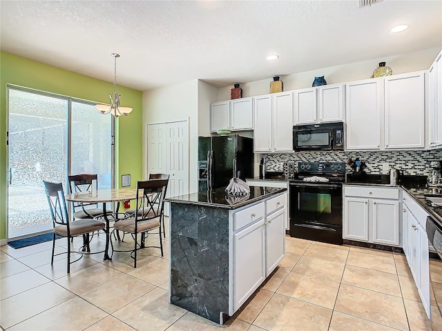 kitchen with light tile patterned flooring, a kitchen island, backsplash, and black appliances