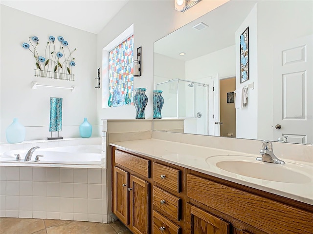 bathroom featuring vanity, visible vents, a bath, tile patterned floors, and a stall shower