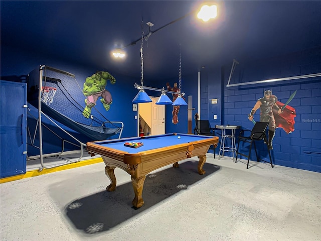 game room featuring concrete block wall and billiards