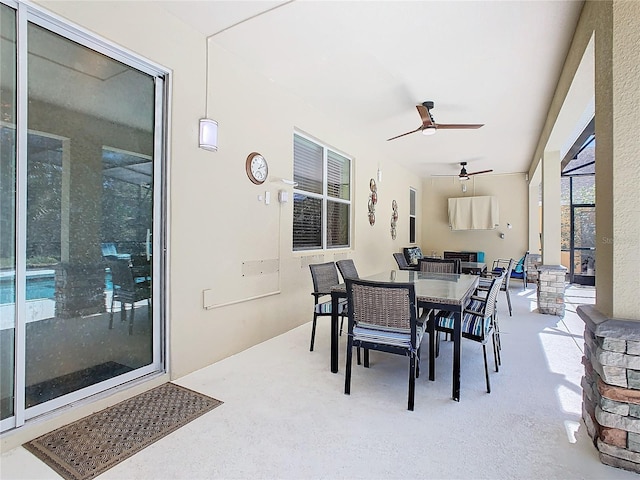 view of patio with outdoor dining space, a lanai, and ceiling fan