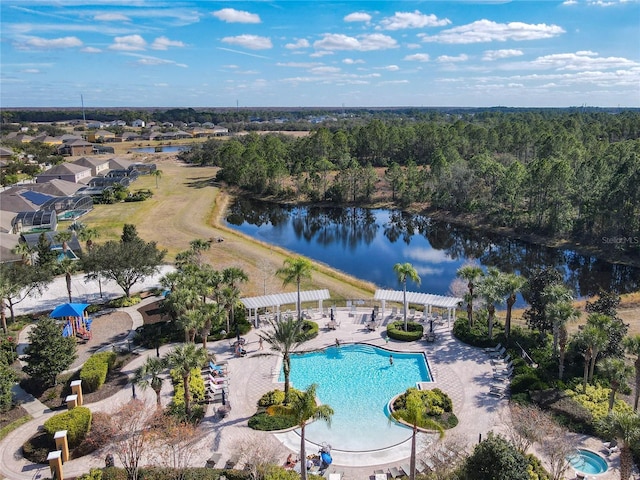 aerial view with a water view and a wooded view