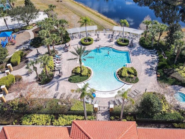 pool featuring a water view, a pergola, and a patio