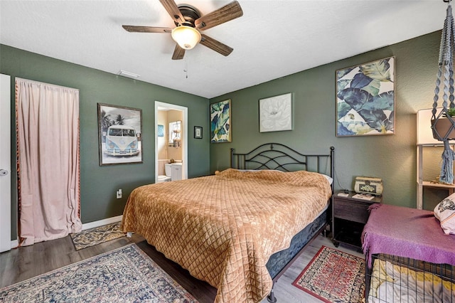 bedroom with baseboards, visible vents, a ceiling fan, ensuite bath, and wood finished floors