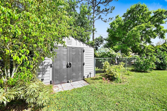 view of shed featuring fence