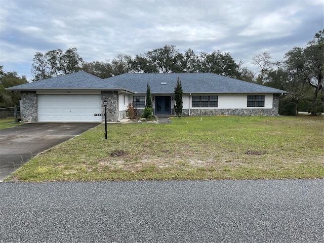 single story home featuring aphalt driveway, roof with shingles, an attached garage, a front yard, and stone siding