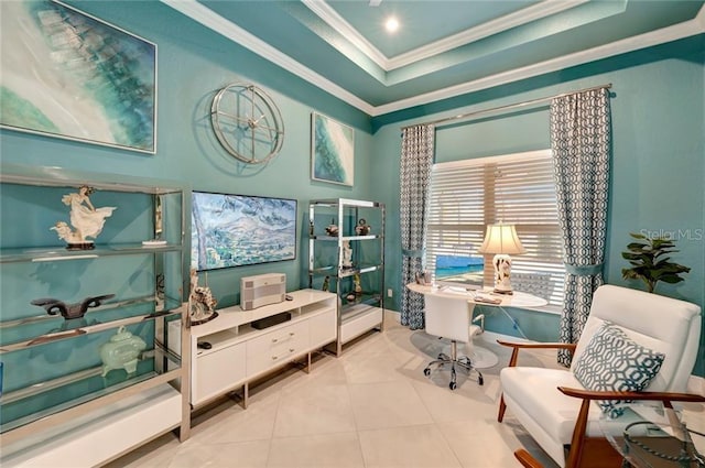 office space with ornamental molding, a tray ceiling, and light tile patterned floors