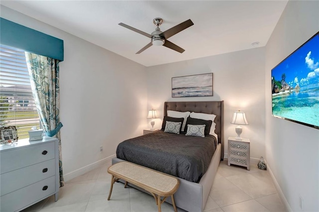 bedroom with ceiling fan, light tile patterned flooring, and baseboards