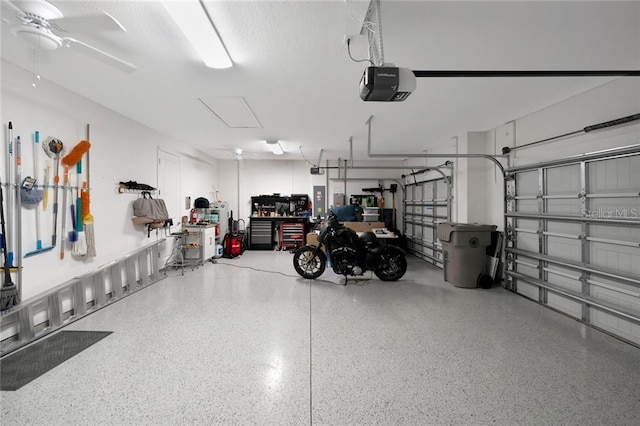 garage with a garage door opener and a ceiling fan