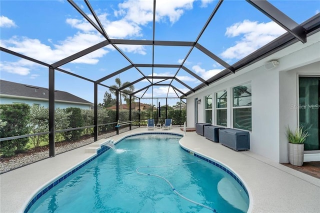 pool with glass enclosure and a patio