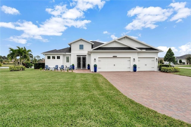 view of front of house with a garage, a front lawn, and decorative driveway