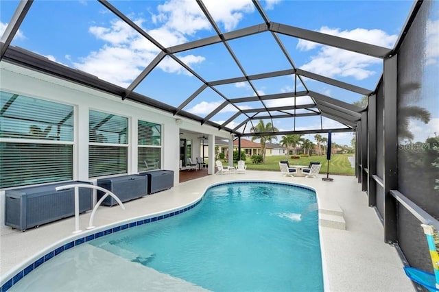 pool with a lanai, a patio area, and ceiling fan