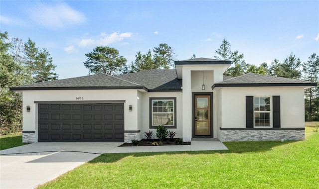 prairie-style house featuring an attached garage, driveway, roof with shingles, stucco siding, and a front yard