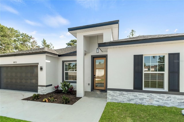 property entrance with a garage, driveway, roof with shingles, and stucco siding