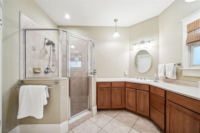 bathroom with a stall shower, vanity, and tile patterned flooring