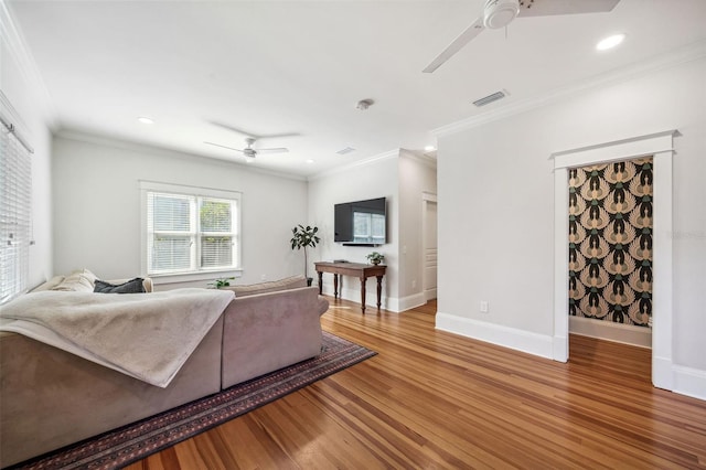 living area featuring visible vents, baseboards, light wood-type flooring, and ceiling fan