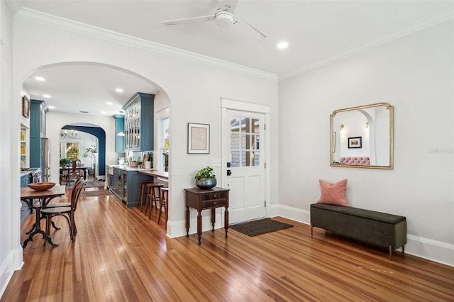 foyer featuring crown molding, recessed lighting, wood finished floors, and baseboards