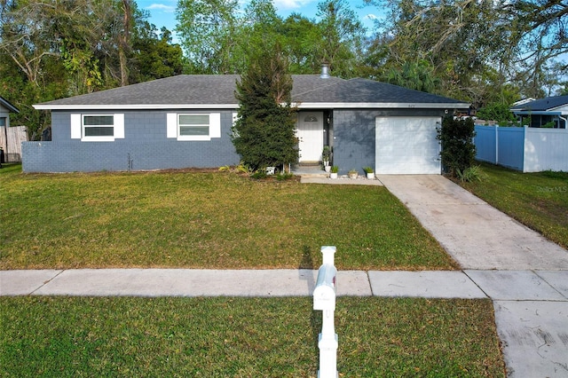 ranch-style home with a garage, concrete driveway, fence, a front lawn, and brick siding