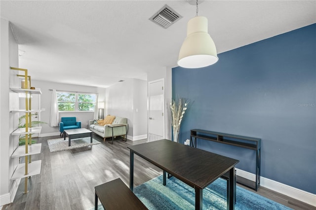 dining room with visible vents, baseboards, and wood finished floors