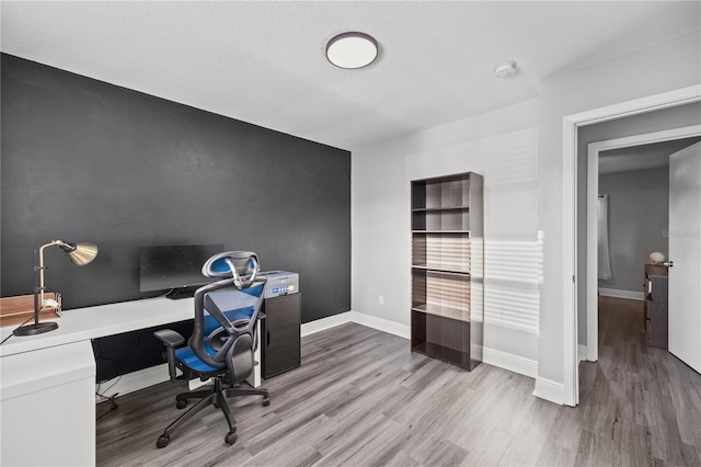 office area featuring baseboards and wood finished floors