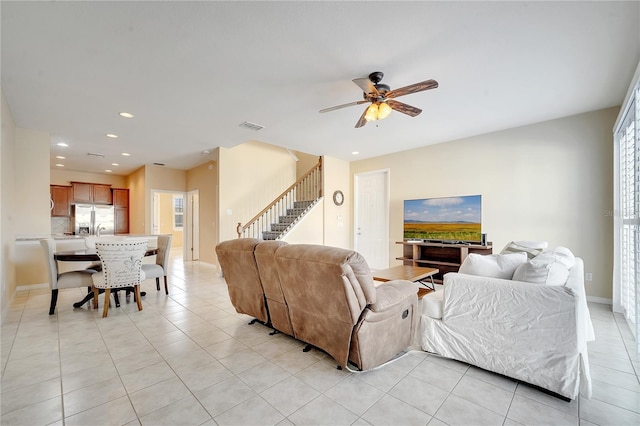 living room with light tile patterned floors, recessed lighting, visible vents, baseboards, and stairs