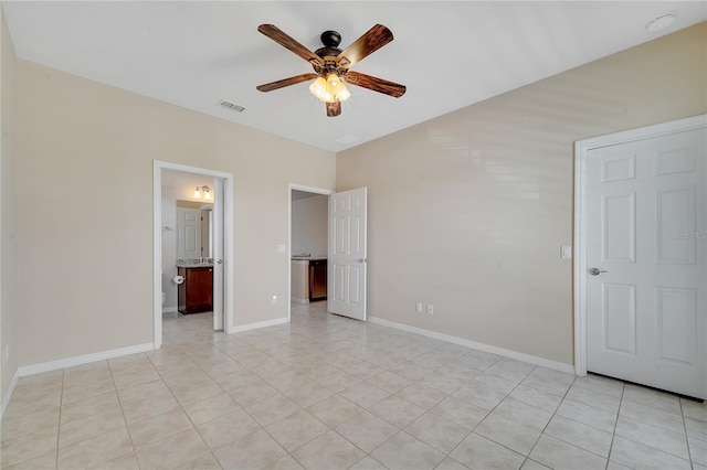 unfurnished bedroom featuring light tile patterned flooring, visible vents, and baseboards