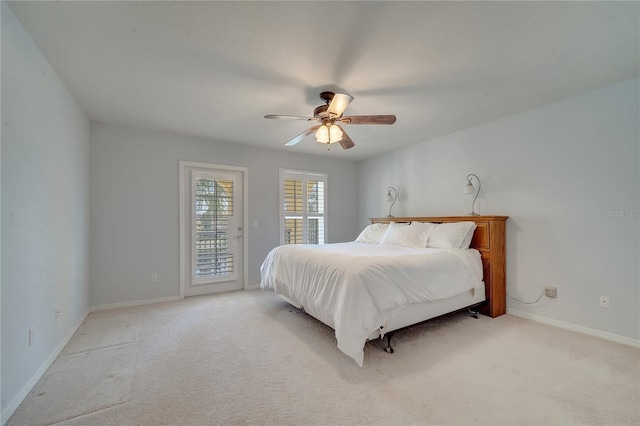 bedroom featuring access to exterior, light colored carpet, ceiling fan, and baseboards