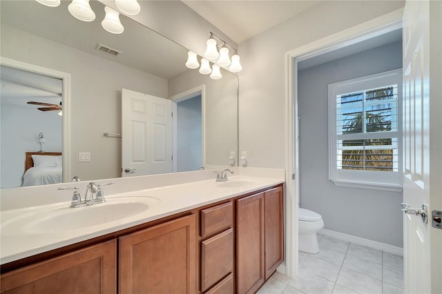 ensuite bathroom featuring tile patterned flooring, visible vents, a sink, and ensuite bathroom