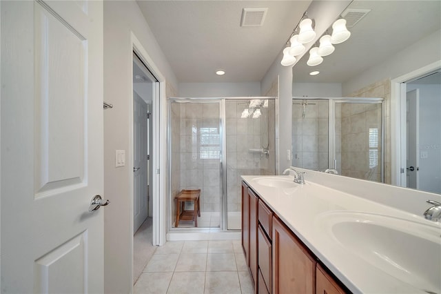 bathroom featuring a stall shower, a sink, and visible vents