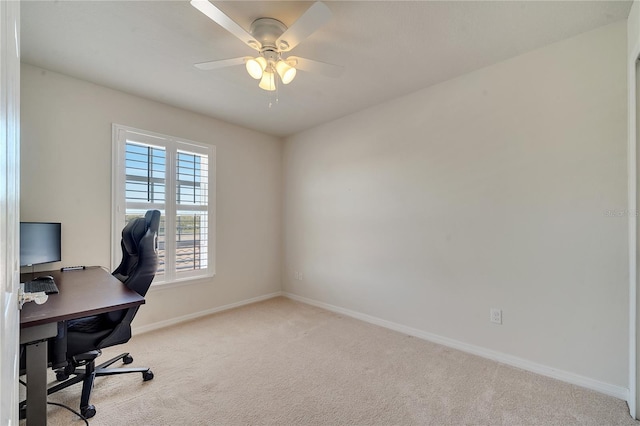 carpeted home office featuring baseboards and a ceiling fan