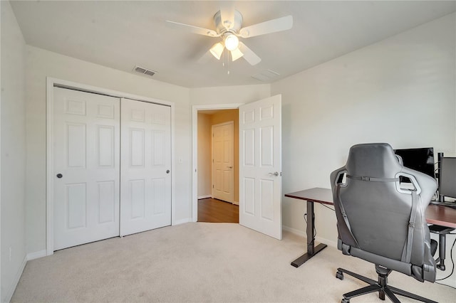 carpeted home office featuring visible vents, ceiling fan, and baseboards