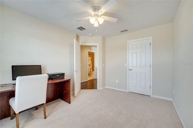 office space with light carpet, visible vents, and baseboards