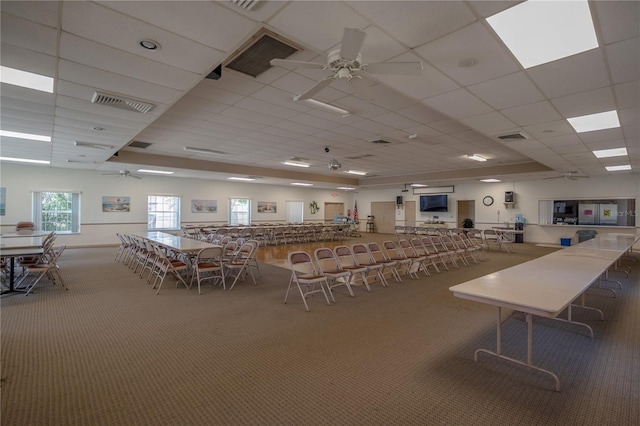 misc room featuring carpet floors, visible vents, and a ceiling fan