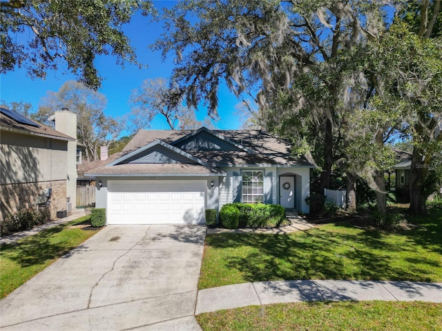 ranch-style house with an attached garage, fence, concrete driveway, stucco siding, and a front lawn