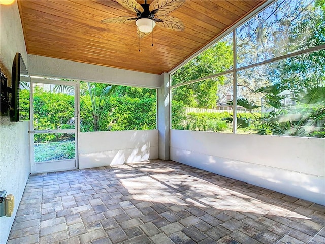 unfurnished sunroom with lofted ceiling, wooden ceiling, and ceiling fan