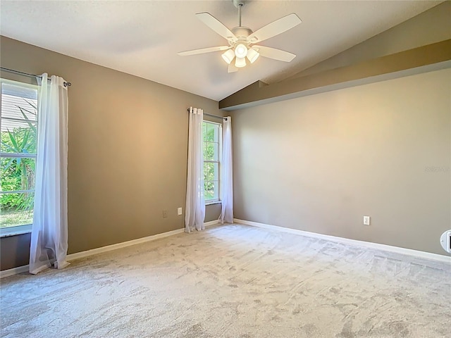 unfurnished room with a ceiling fan, carpet, vaulted ceiling, and baseboards