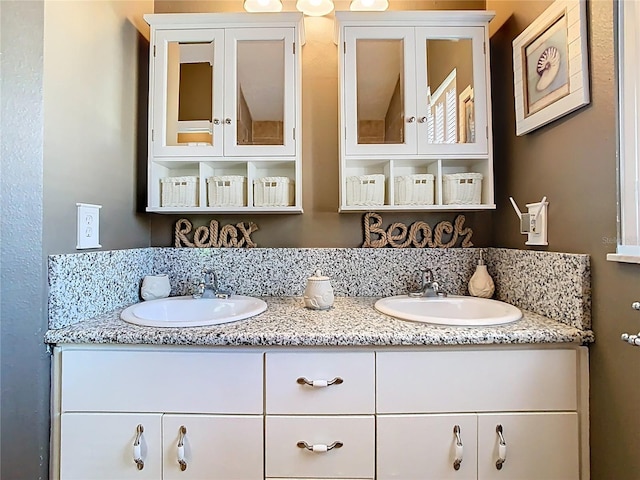 full bathroom with double vanity and a sink