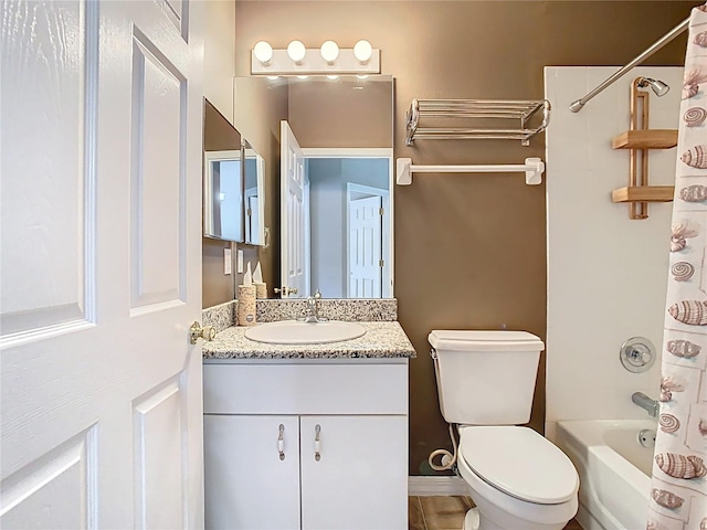 bathroom featuring toilet, shower / tub combo with curtain, and vanity